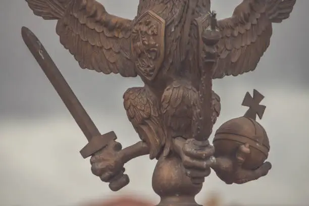 Photo of three-headed eagle with sword and sceptre of power symbol of tsarist Russia