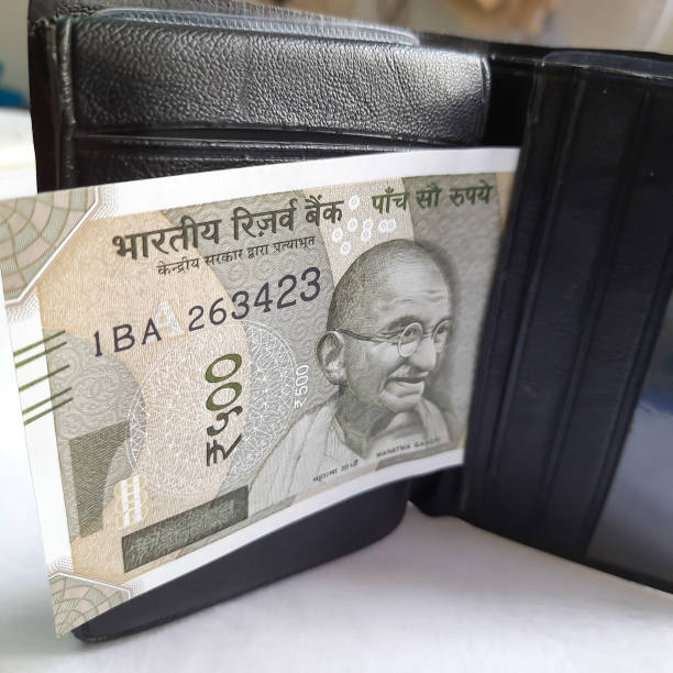 istock Indian new rupees currency notes arranged orderly number upwards manner with all rupee coins in white paper in wallet 1273870145