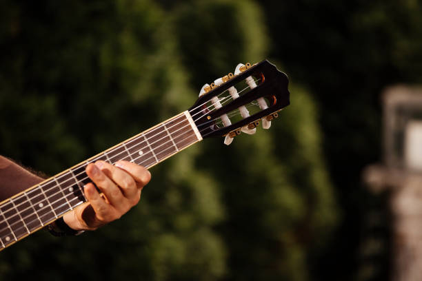 Close up of male hands playing acoustic guitar. stock photo