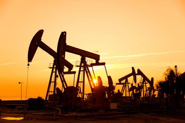 istock Oil pumps and rig at sunset 1273872105