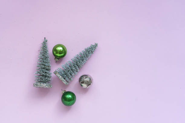 istock Artificial Christmas tree and Christmas tree balls on a pink background 1273873338