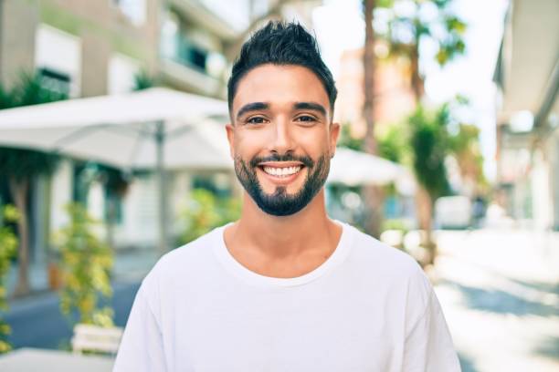 istock Young arab man smiling happy walking at the city. 1273874357