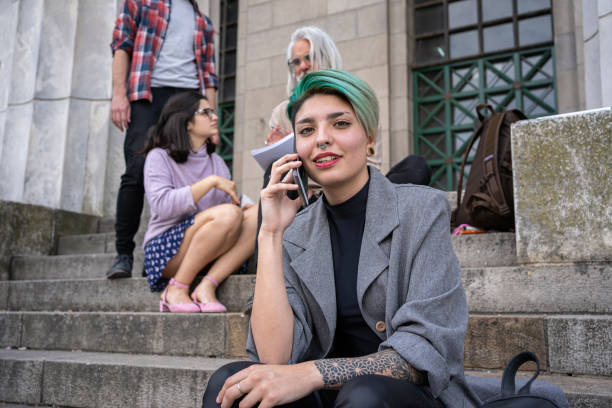 istock Girl having a phone call after lectures 1273875899