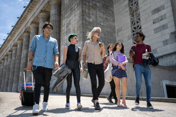 istock Group of students walking with their professor home after class 1273875927