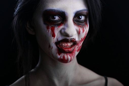 Young woman in halloween horror make-up as a vampire. About 20 years old, Caucasian female.