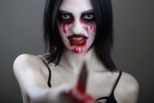 Young woman in halloween horror make-up as a vampire. About 20 years old, Caucasian female.