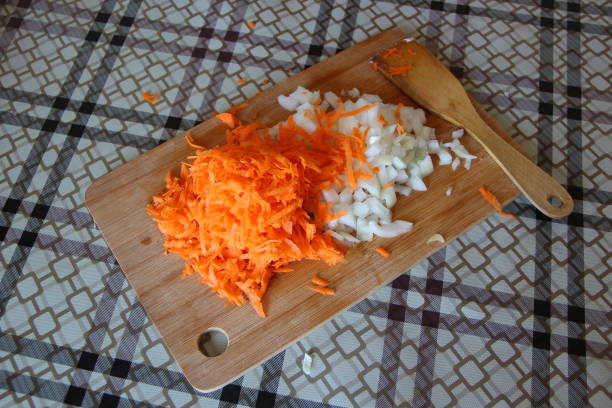 istock Carrots and onion on a cutting board 1273876399
