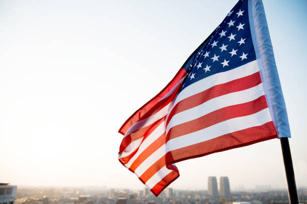istock American flag waving in sunset 1273876924