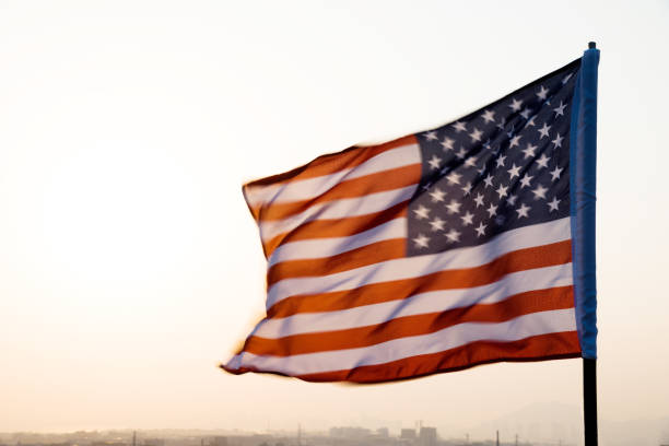 istock American flag waving in sunset 1273876964
