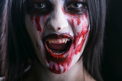 Young woman in halloween horror make-up as a vampire. About 20 years old, Caucasian female.