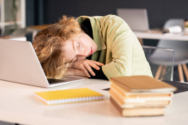 istock Young exhausted female student or office manager keeping head on hands 1273877490