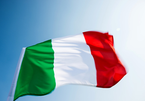 Italian flag waving in the sky.