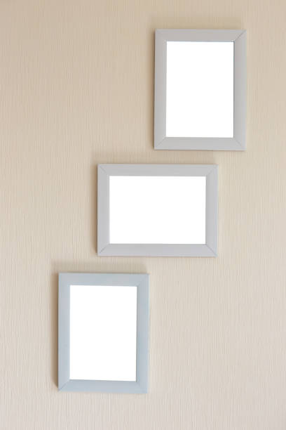 istock Collage of three white frames on a beige wall 1273879376