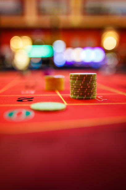 istock Casino roulette table with gambling chips 1273880107