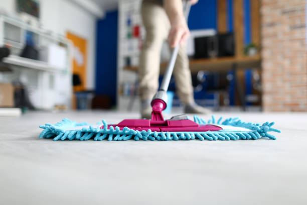 istock Male hand hold blue plastic mop against modern office closeup 1273880367