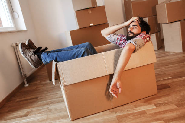 Young man moving into a new home.