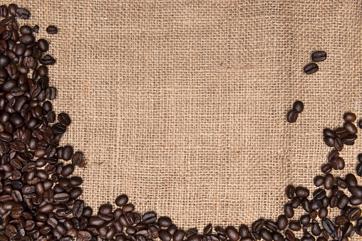 Direct above view of roasted coffee beans  on burlap sack.