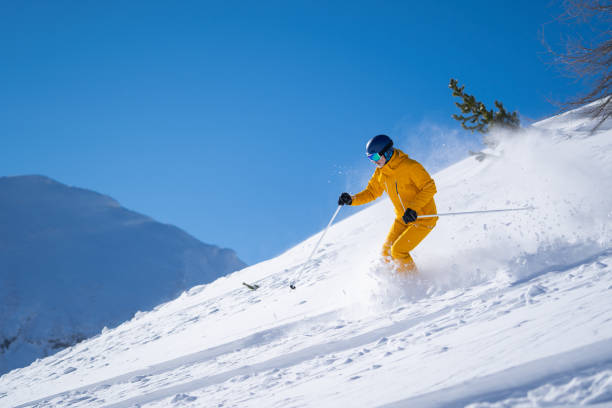 istock powder snow skiing on sunny day 1273886669