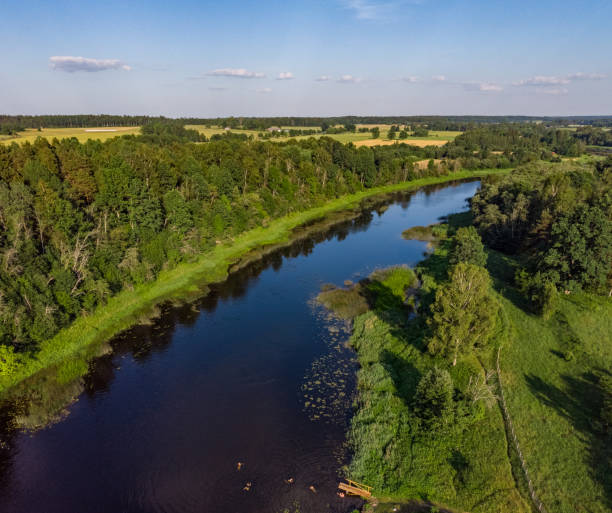 istock Areal countryside view from drone with small river Venta. 1273886860