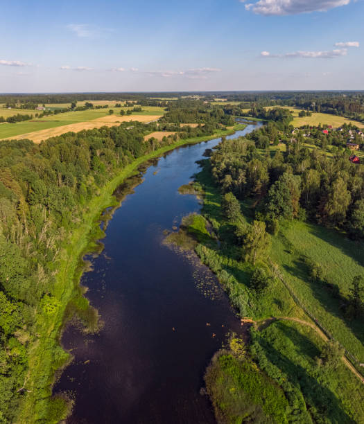 istock Areal countryside view from drone with small river Venta. 1273886865