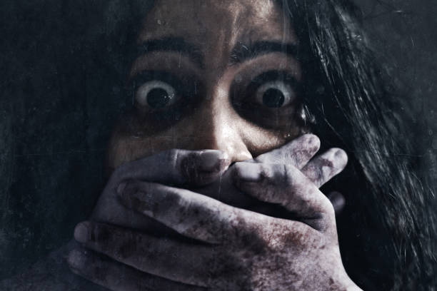 Scared woman on dark background