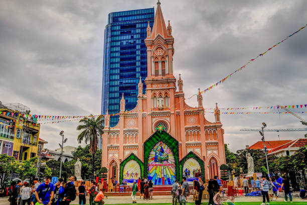 Danang, Vietnam - December 30, 2019: People gathered in the plaza out front of the Pink Cathedral in Da Nang Vietnam