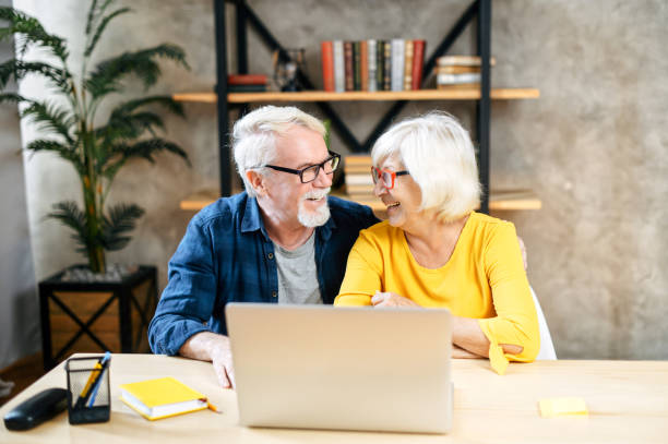 istock A happy senior couple is using the laptop indoor 1273888477