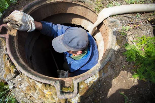 istock Worker cleans the sewer hatch.A worker cleans a sewer hatch. A man in the hatch. 1273888620