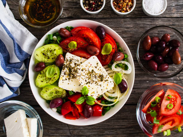 istock Greek salad on wooden table 1273888972