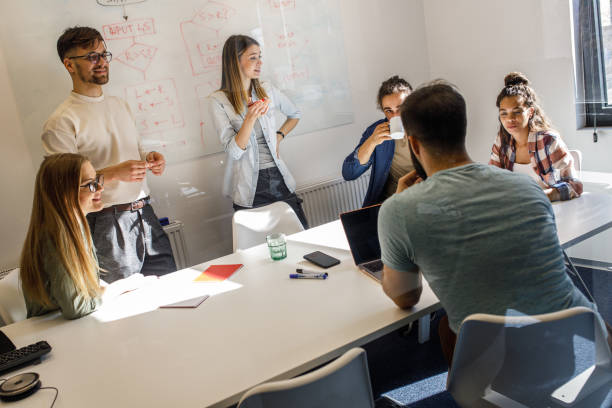 istock Group of programmers an designers in conference room. 1273889971