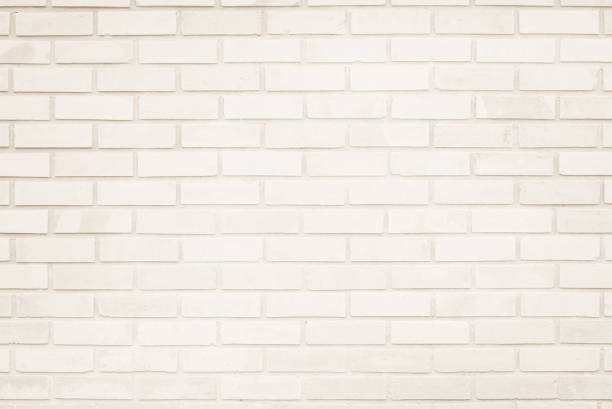 istock Empty Background of wide cream brick wall texture. Old brown brick wall concrete or stone pattern nature, wallpaper limestone abstract floor/Grid uneven interior rock. Home & office design backdrop. 1273890251