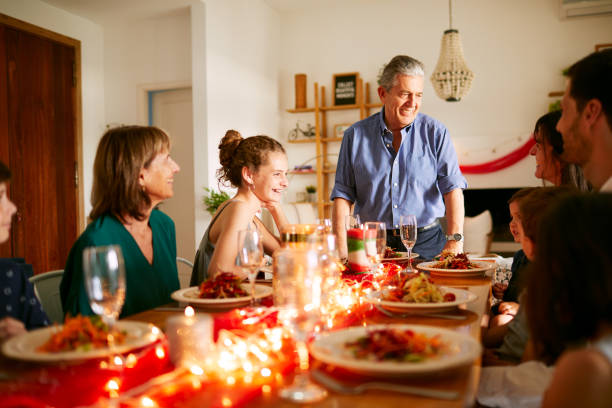 istock A grandfather giving a speech at the Christmas dinner table. 1273894215