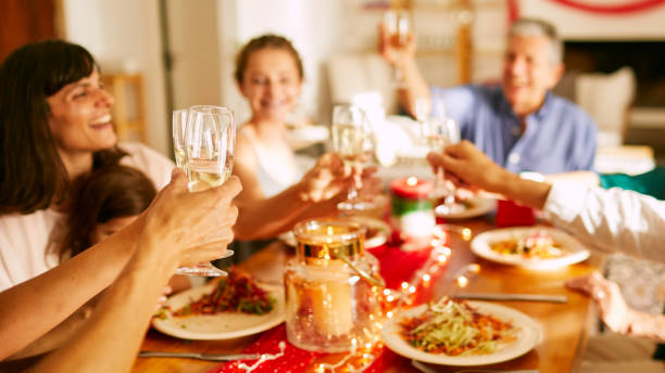 istock Hands rising champagne flutes at Christmas dinner. 1273894217