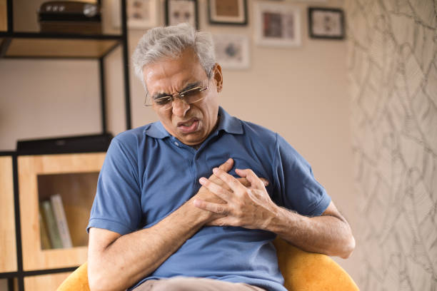Old man suffering with heart disease Senior man suffering with heart disease at home male chest pain stock pictures, royalty-free photos & images