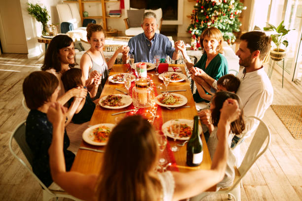 istock A family praying before Christmas dinner. 1273894638