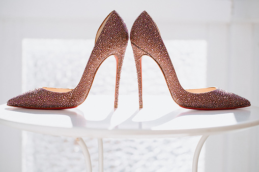Glamorous bridal wedding shoes with backlight, selective focus