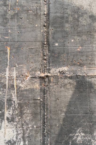 istock Old seamed concrete wall. Grungy corroded background 1273896730