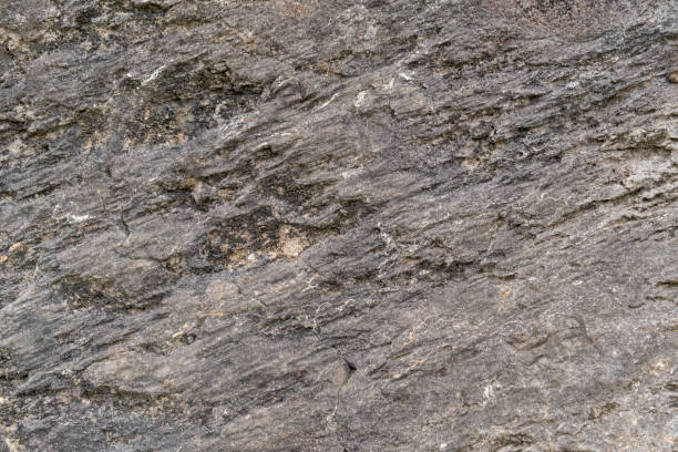 istock Grungy cracked stone texture from natural rock retro style. Weathered ancient wall background 1273897468