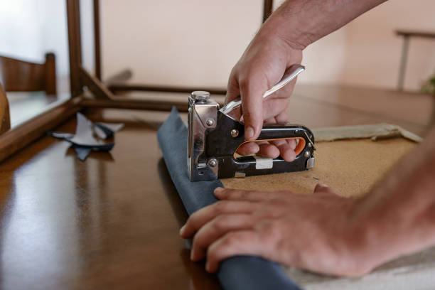 Man upholstering chair at home