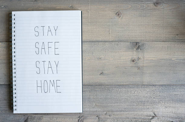istock Stay safe stay home text with copy space on wooden background. 1273897694