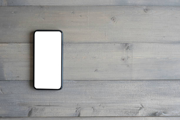 istock Blank screen mobile phone for text and copy space on wooden background. 1273897716