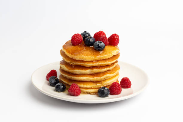 Delicious pancakes with raspberry and blueberry on White background stock photo