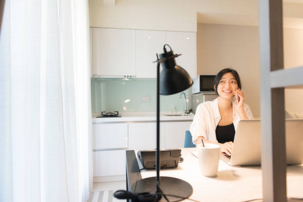 istock asian woman working at home 1273902347