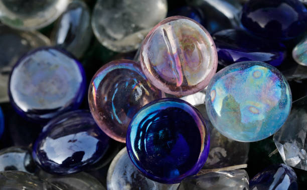 istock Iridescent glass marbles and blue marbles 1273903884
