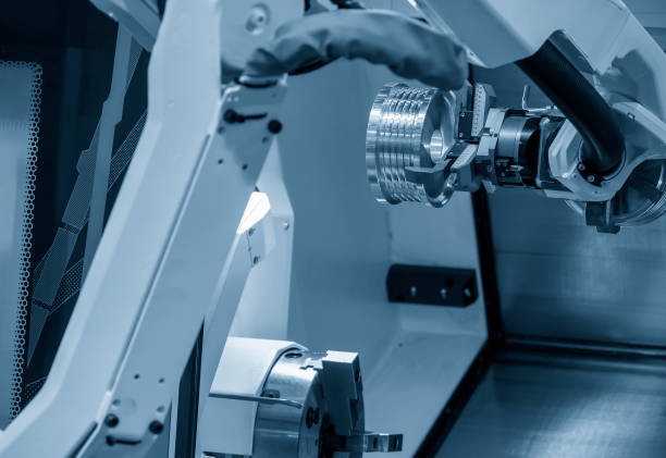 istock The hi-technology CNC lathe machine operation with gripping robotic system. 1273904136