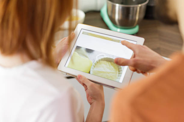 istock Young couple preparing a pie in the kitchen 1273905797