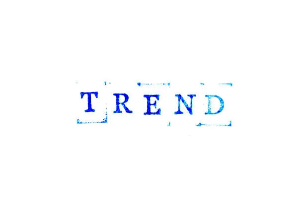 Photo of Blue ink of rubber stamp in word trend on white paper background