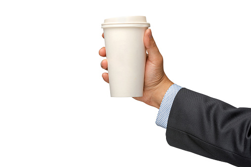 Businessman holding out a paper cup of coffee on white background