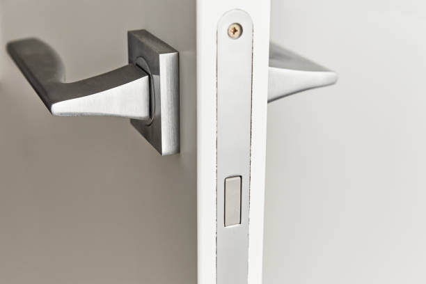 istock Silver door handle on a white door.  Furniture accesories, interior element 1273907742