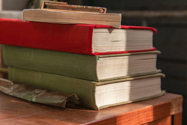 istock Old books on a wooden nightstand 1273908012